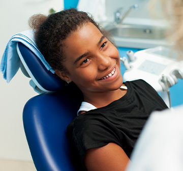 Teen girl smiling during dental exam