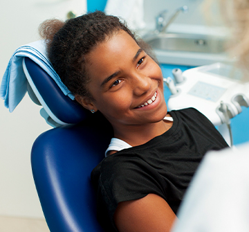 Teen girl smiling during dental exam