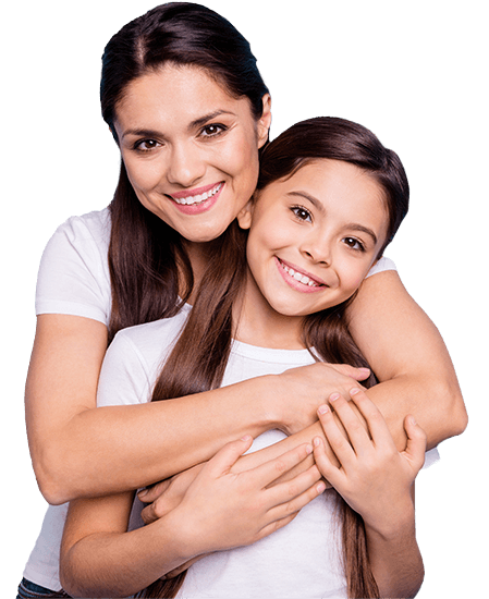 Mother hugging her smiling daughter