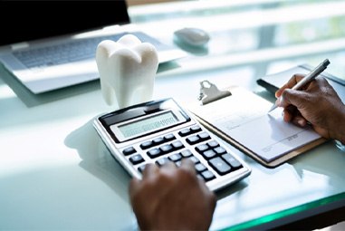 Patient calculating the cost of braces on calculator