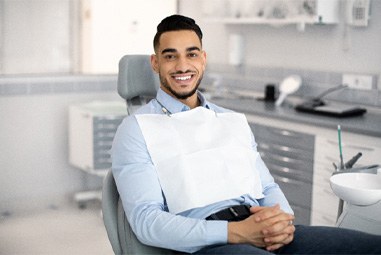 Man smiling while sitting in orthodontist's office