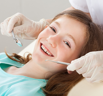 Girl smiling during dental checkup