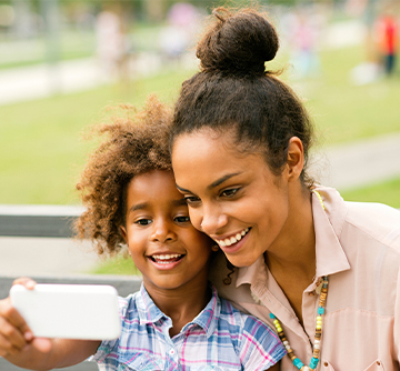 Mother and child smiling after tooth-colored fillings