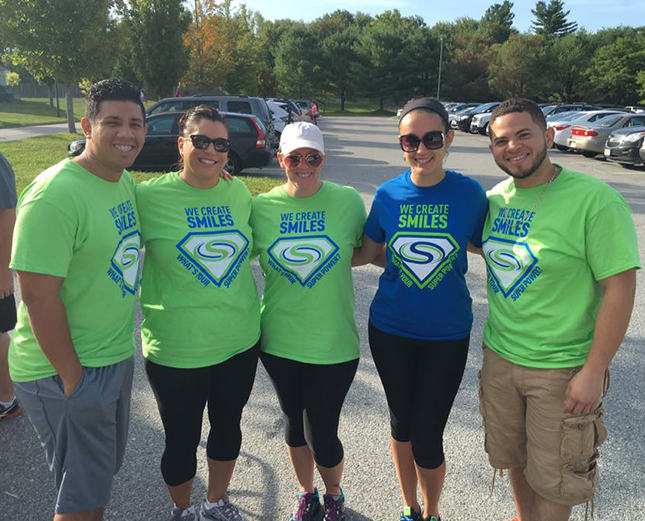 Team members wearing matching shirts at community event