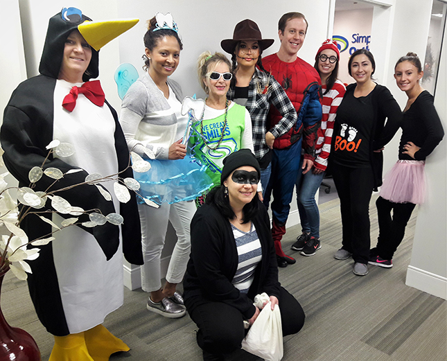 Team members in Halloween costumes