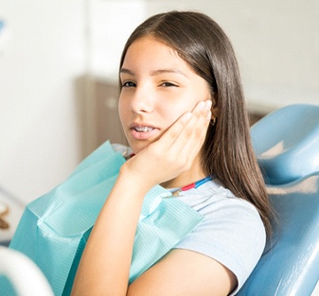 Girl with braces visiting her Randolph children’s emergency dentist