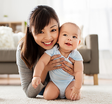 Mother holding baby after fluoride treatment