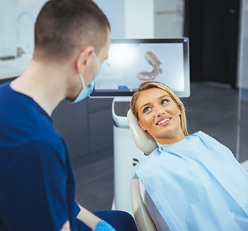 Patient smiling at dental assistant during Invisalign consultation