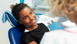 Teen girl smiling during dental checkup