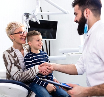 Parent and child smiling at pediatric dentist in Randolph