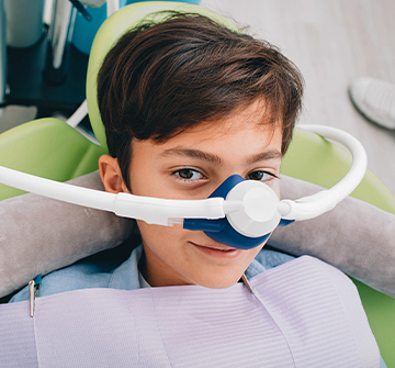 Teen boy with nitrous oxide nose mask in place