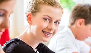 Smiling young girl with braces