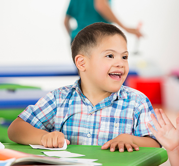 Young boy in classroom smiling