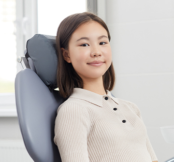 Teen girl smiling during dental checkup