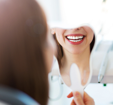 Teen looking at smile after tooth-colored filling