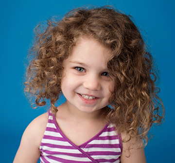 Child smiling after dental sealant placement