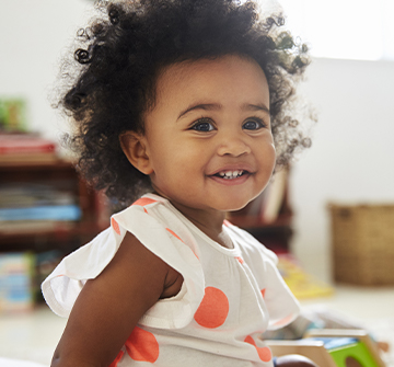 Child smiling after fluoride treatment