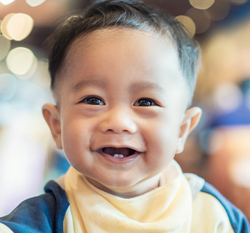 Toddler smiling after frenectomy