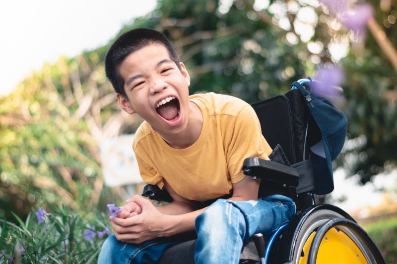 Child in wheelchair smiling
