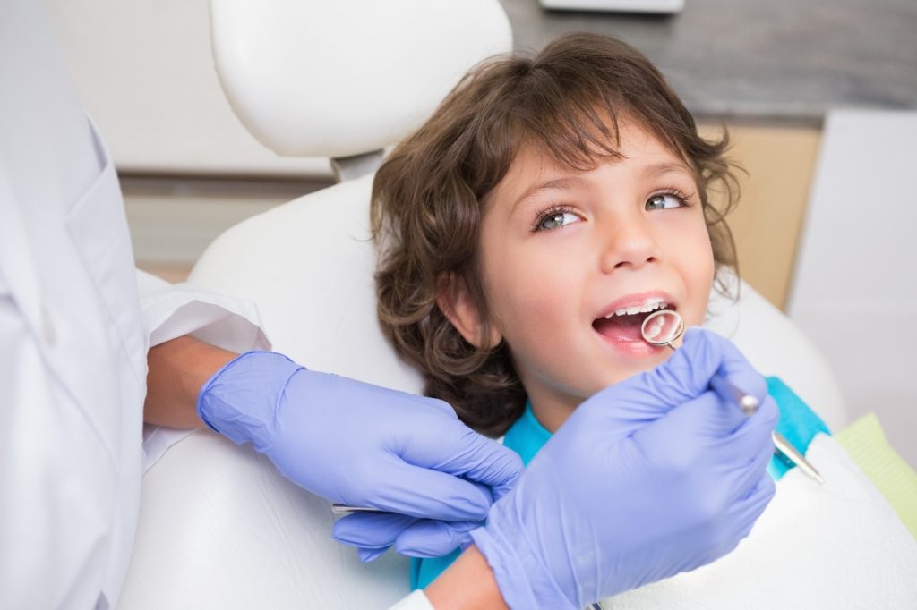 Boy smiling at dentist during dental checkup