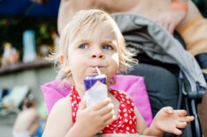 Kid sipping juice that causes children's cavities