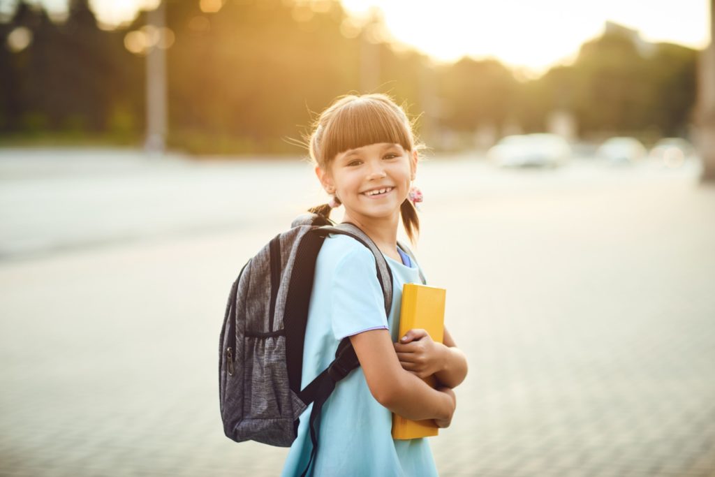 Child smiling while walking to school