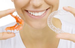 a patient holding their retainer 