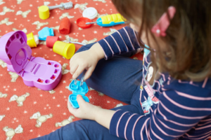 a child playing with dentistry-themed toys 