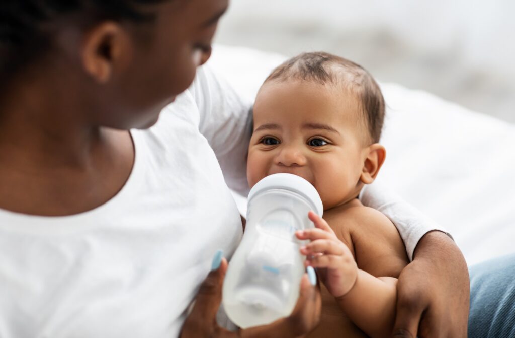 Mom holding baby drinking bottle