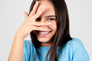 a child with braces smiling