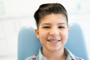 a child with braces smiling